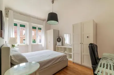 a bedroom with a bed and a glass table at GuestHost - Bright Flat in Lungotevere Flaminio in Rome