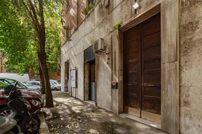 a motorcycle parked next to a building with a garage at GuestHost - Bright Flat in Lungotevere Flaminio in Rome