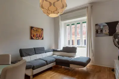 a living room with a couch and a window at GuestHost - Bright Flat in Lungotevere Flaminio in Rome