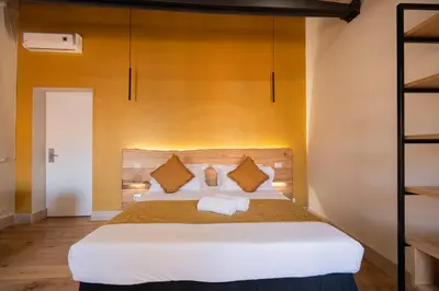 a bedroom with a large bed with yellow walls at Terrace 34 in Rome