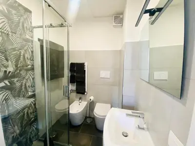 a bathroom with a toilet and a sink and a shower at Domus 14 in Rome