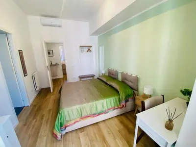 a bedroom with a large bed and a table at Domus 14 in Rome
