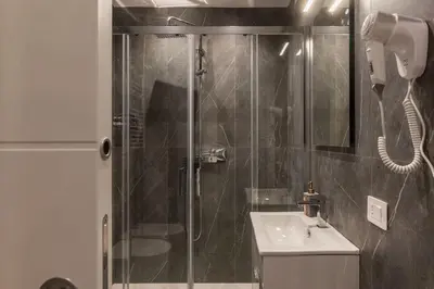 a bathroom with a shower and a sink at GuestHost - Metro Cipro Lovely Apartment X6 in Rome