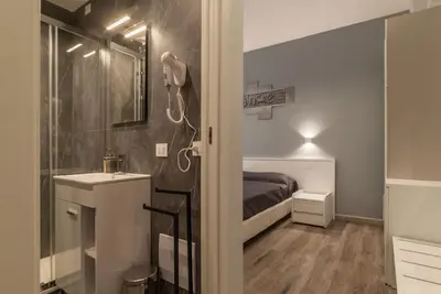 a small bathroom with a bed and a sink at GuestHost - Metro Cipro Lovely Apartment X6 in Rome
