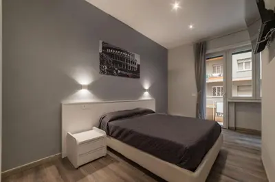 a bedroom with a bed and lights on the wall at GuestHost - Metro Cipro Lovely Apartment X6 in Rome