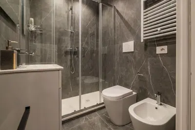 a bathroom with a shower and a toilet and a sink at GuestHost - Metro Cipro Lovely Apartment X6 in Rome