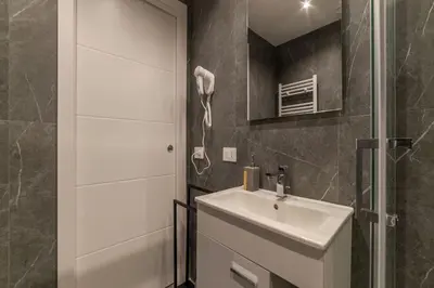 a bathroom with a sink and a shower at GuestHost - Metro Cipro Lovely Apartment X6 in Rome