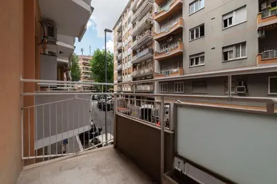 a balcony with a view of a building at GuestHost - Metro Cipro Lovely Apartment X6 in Rome