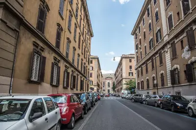 a street with cars parked on the side of the road at Grandis Rooms in Rome