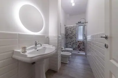 a white bathroom with a sink and a toilet at Vatican Shabby apartment double bedrooms in Rome