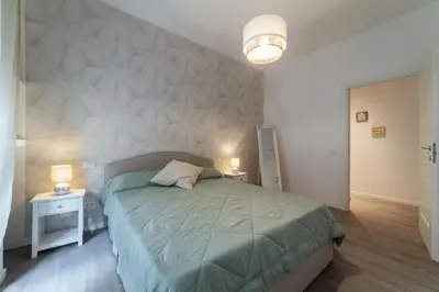 a bedroom with a bed and two tables and a lamp at Vatican Shabby apartment double bedrooms in Rome