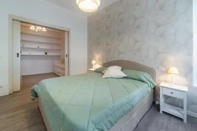 a bedroom with a bed with a green comforter at Vatican Shabby apartment double bedrooms in Rome
