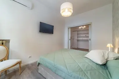 a bedroom with a bed and a tv on the wall at Vatican Shabby apartment double bedrooms in Rome