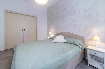a bedroom with a large bed and a white wall at Vatican Shabby apartment double bedrooms in Rome