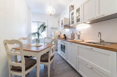 a kitchen with a table and chairs and a sink at Vatican Shabby apartment double bedrooms in Rome