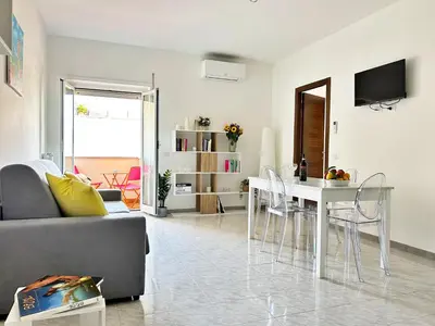 a living room with a white table and chairs at Nala's Vatican House in Rome
