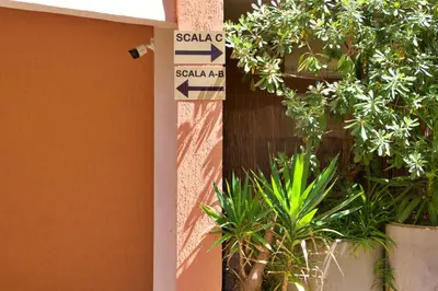 a street sign in front of a building with plants at Nala's Vatican House in Rome