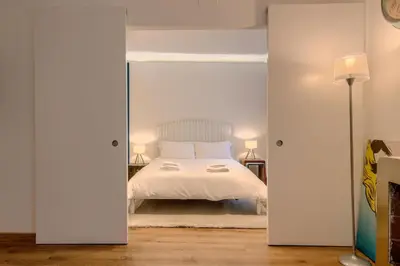 a bedroom with a white bed and two lamps at La Dimora di Piazza Navona in Rome
