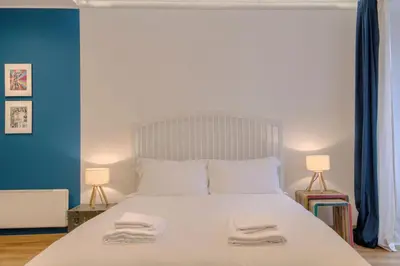 a bedroom with a large white bed with two towels on it at La Dimora di Piazza Navona in Rome