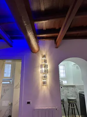 a chandelier hanging from a wall in a room at Suite at the Coliseum in Rome