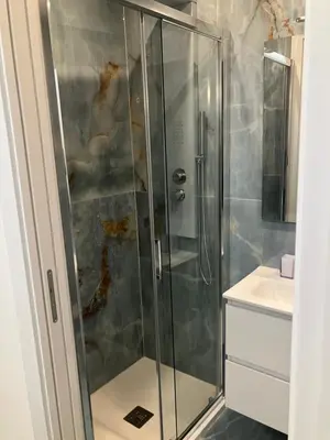 a shower with a glass door in a bathroom at Principe Umberto piano terra in Rome