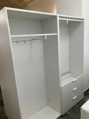 a white closet with white doors and drawers at Principe Umberto piano terra in Rome