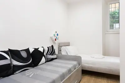 a living room with a couch and a bed at Aventino Urban Place by One Up Hospitality in Rome