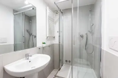 a white bathroom with a sink and a shower at Mini apartment Cairoli 1 - Zeno 42 in Rome
