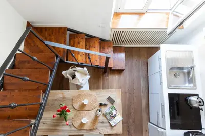 a tiny house with a staircase and a table at Mini apartment Cairoli 1 - Zeno 42 in Rome