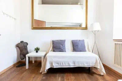 a bedroom with a bed and a mirror on the wall at Mini apartment Cairoli 2 - Zeno 42 in Rome