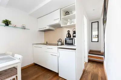 a white kitchen with white cabinets and a sink at Mini apartment Cairoli 2 - Zeno 42 in Rome
