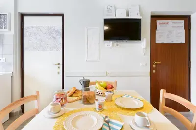 a dining room table with plates and fruit on it at Suite Laterani 3 bedrooms with parking in Rome