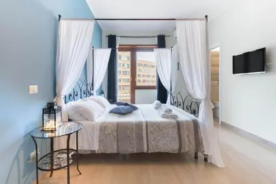 a bedroom with a bed and a window and a table at Suite Laterani 3 bedrooms with parking in Rome