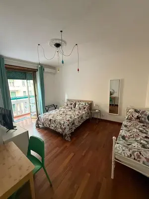 a bedroom with two beds and a desk and a table at Casa Letizia - Rome Prati Vatican - Intero appartamento in Rome