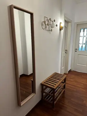 a mirror and a wooden stool in a room at Casa Letizia - Rome Prati Vatican - Intero appartamento in Rome