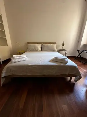 a large bed in a room with a wooden floor at Casa Letizia - Rome Prati Vatican - Intero appartamento in Rome