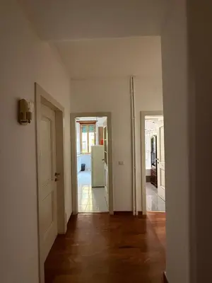 an empty room with a kitchen and a hallway with a refrigerator at Casa Letizia - Rome Prati Vatican - Intero appartamento in Rome