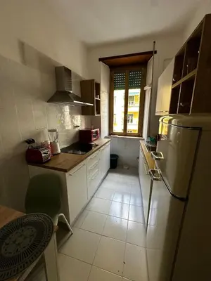 a kitchen with white cabinets and a refrigerator at Casa Letizia - Rome Prati Vatican - Intero appartamento in Rome
