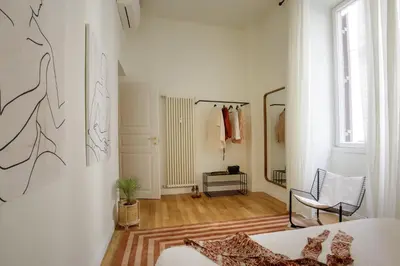 a white room with a bed and a mirror at Domus Regia - Luxury Experience in Rome