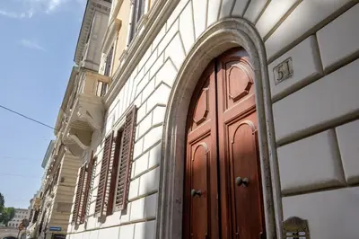 a building with a wooden door on the side of it at Domus Regia - Luxury Experience in Rome
