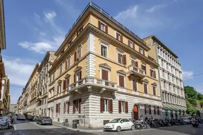 a large building with cars parked in front of it at Domus Regia - Luxury Experience in Rome