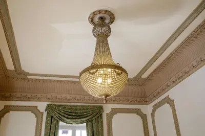 a large chandelier hanging from a ceiling at Domus Regia - Luxury Experience in Rome