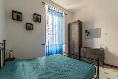 a bedroom with a bed and a large window at GuestHost - Comfy Apartment near Vatican City! in Rome