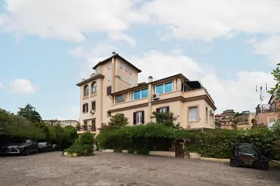 a large house in the middle of a parking lot at GuestHost - Comfy Apartment near Vatican City! in Rome