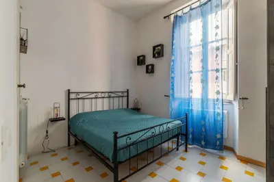 a bedroom with a bed and a window at GuestHost - Comfy Apartment near Vatican City! in Rome