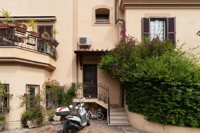 a scooter parked in front of a building at GuestHost - Comfy Apartment near Vatican City! in Rome