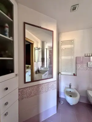 a bathroom with a mirror and a sink and a toilet at Raffaella Vatican House in Rome