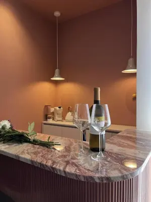a kitchen with two glasses of wine on a counter at Raffaella Vatican House in Rome