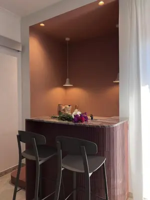 a bar in a kitchen with two chairs and a counter at Raffaella Vatican House in Rome