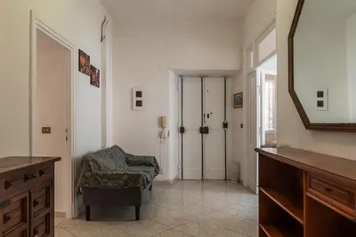 a bathroom with a mirror and a chair and a closet at GuestHost - Piazzale Clodio Apartment in Rome